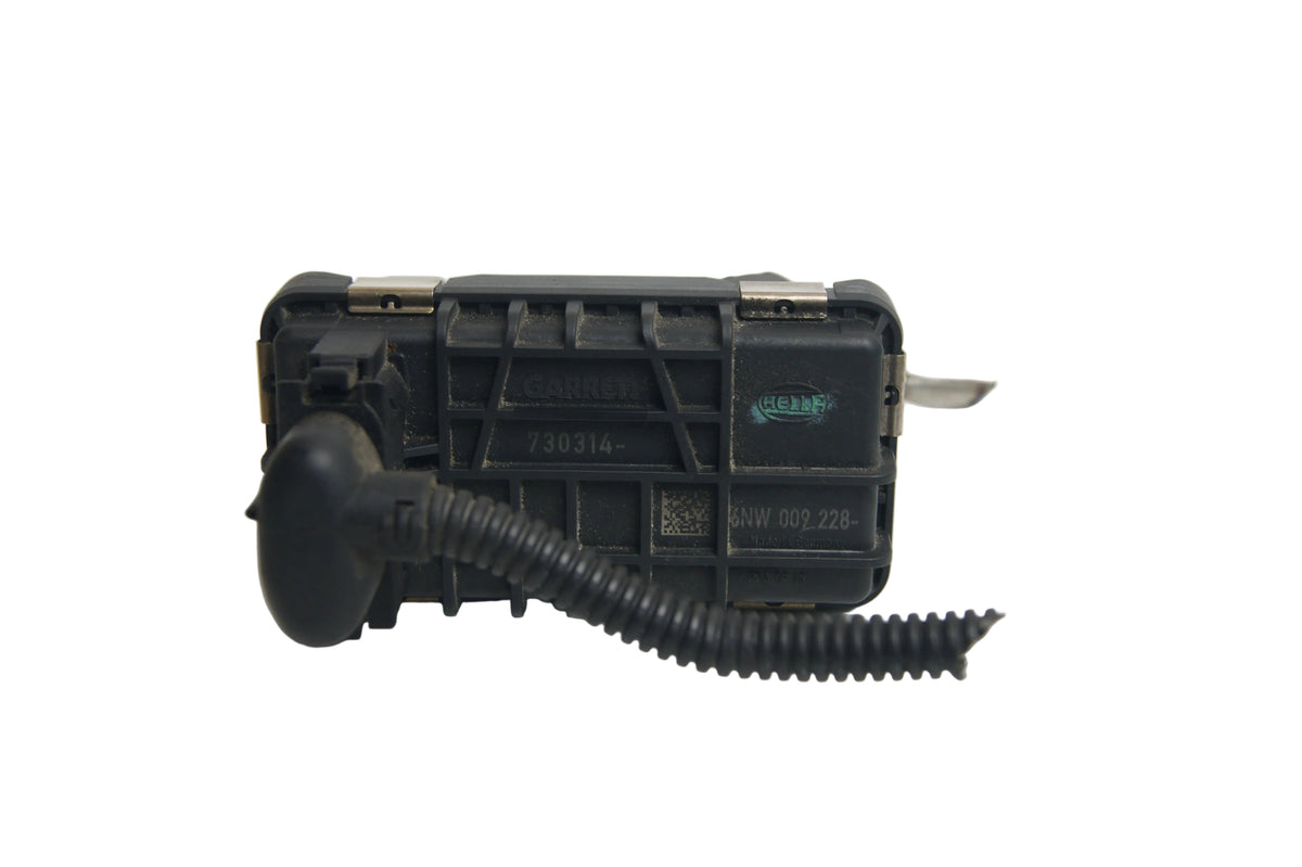 A black plastic automotive switch module with a corrugated black cable attached, photographed on a plain white surface.